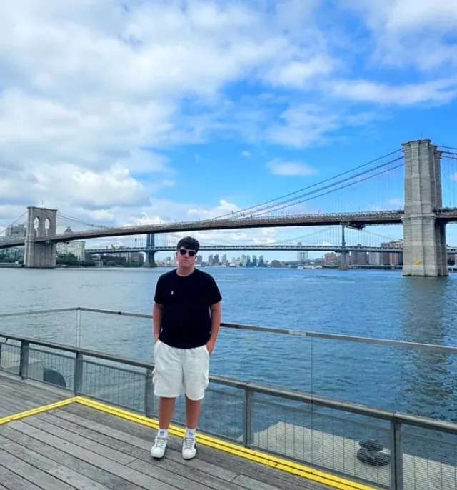 Garen Cilbiyikoglu on a pier with the Brooklyn Bridge behind him