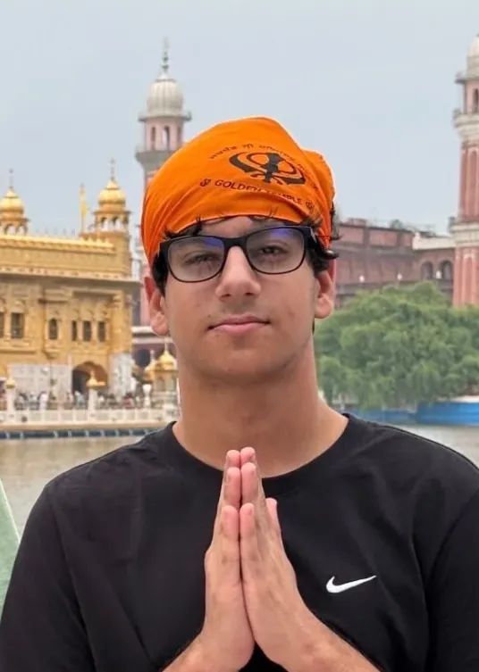 Ivan Kalra with hands folded in front of the Golden Temple