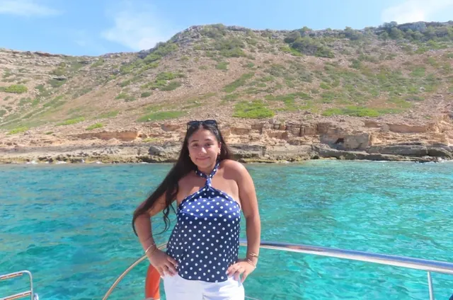 Mehek Ahuja on a boat over turquoise water