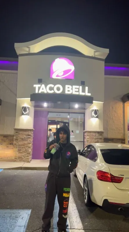 Shaunak Malhotra standing outside a Taco Bell at night